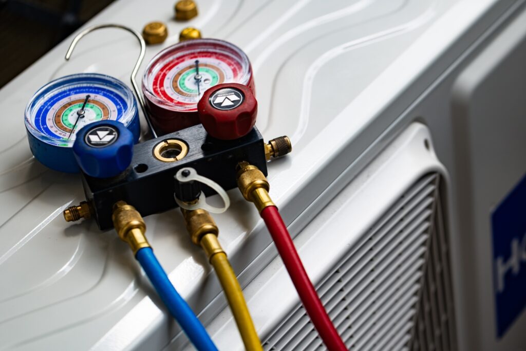 Refrigerant Manifold Gauges Connected to AC Unit