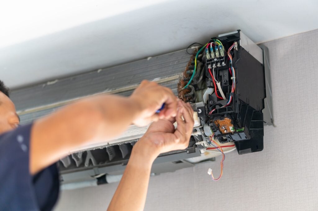 Repairman fix air conditioning systems, Technicians man using screwdrivers service for repair and maintenance of air conditioners.