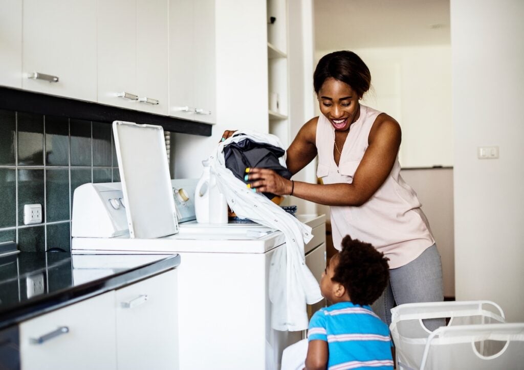 kid helping mom doing the laundry