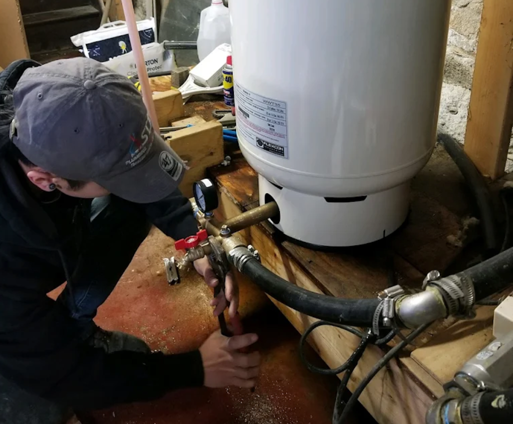 New era worker fixing water heater