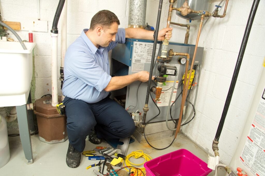 Hvac technician repairs furnace