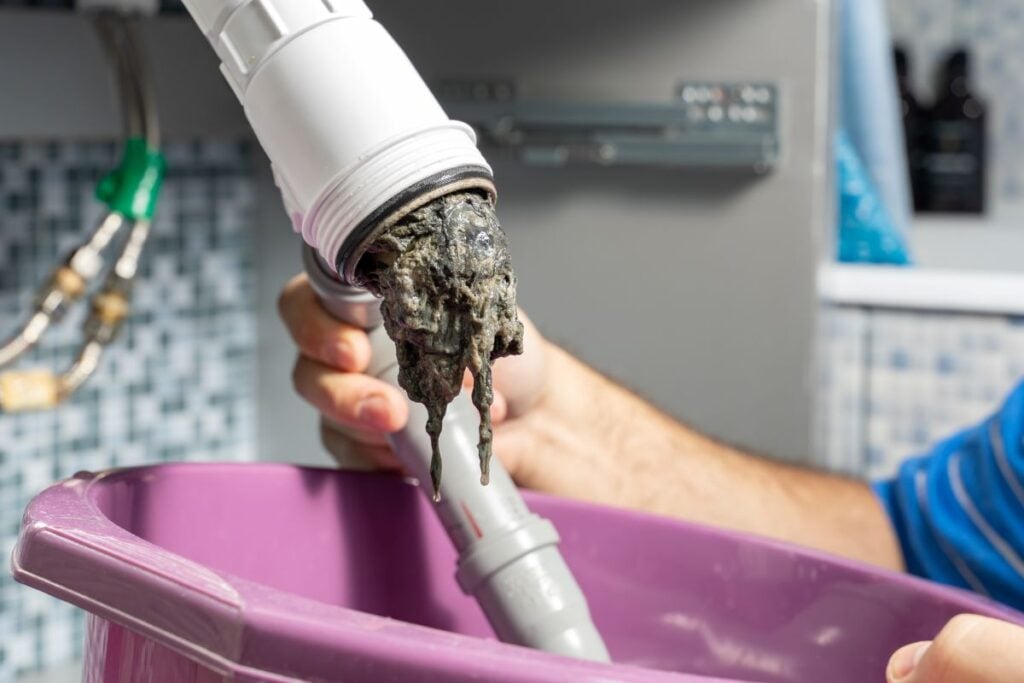 drain cleaning pipe clogged with dirt