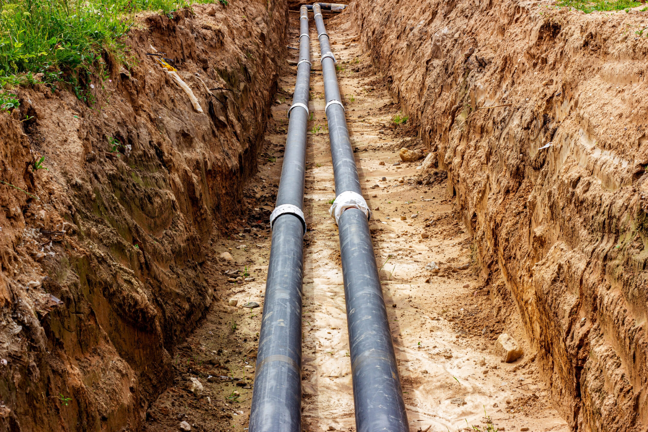 Installation of the distribution unit of heating and water supply network. Frame for connecting pipes in the trench of ground.