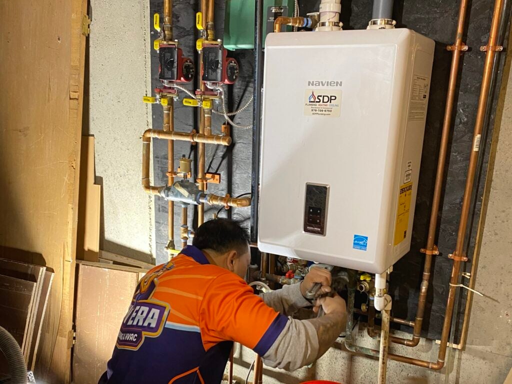 tankless water heater cost worker repairing unit