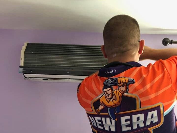 ductless air conditioner man repairing indoor unit