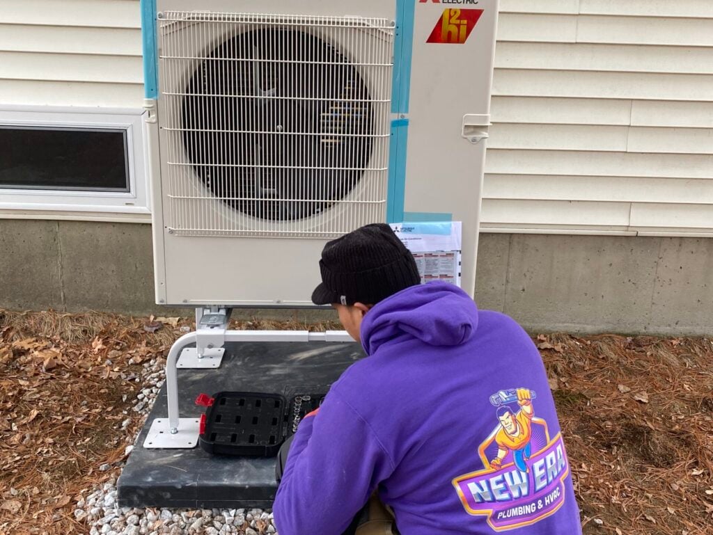 ac compressor worker repairing ac unit