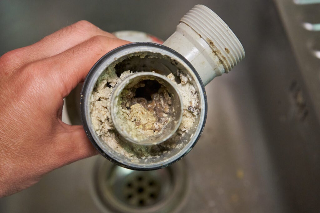 clogged drain filled with dust
