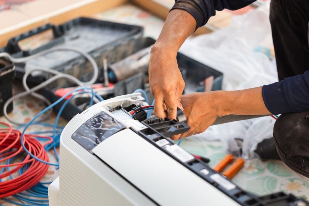 emergency ac repair worker repairing unit