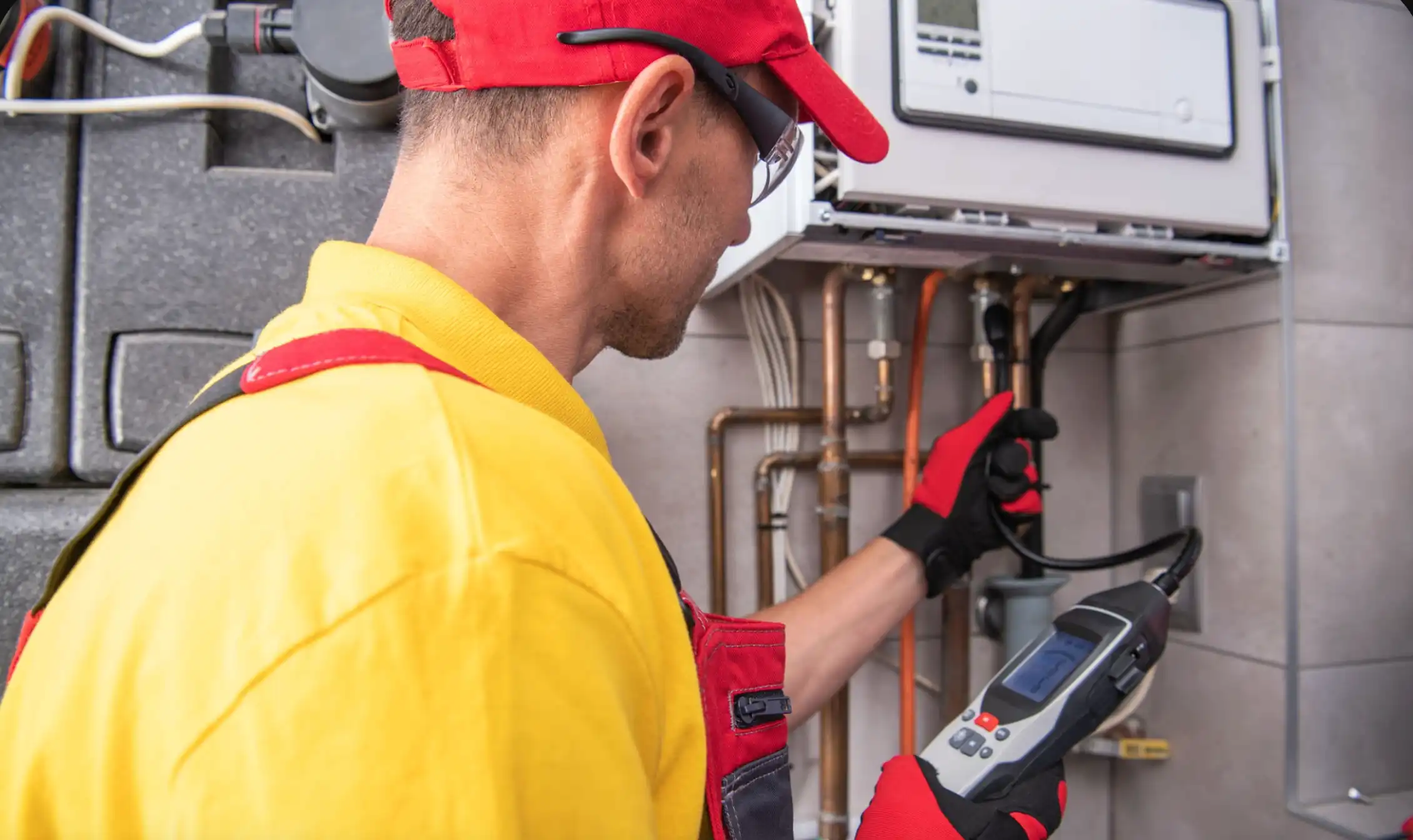 Technician inspecting plumbing system with a digital tool.